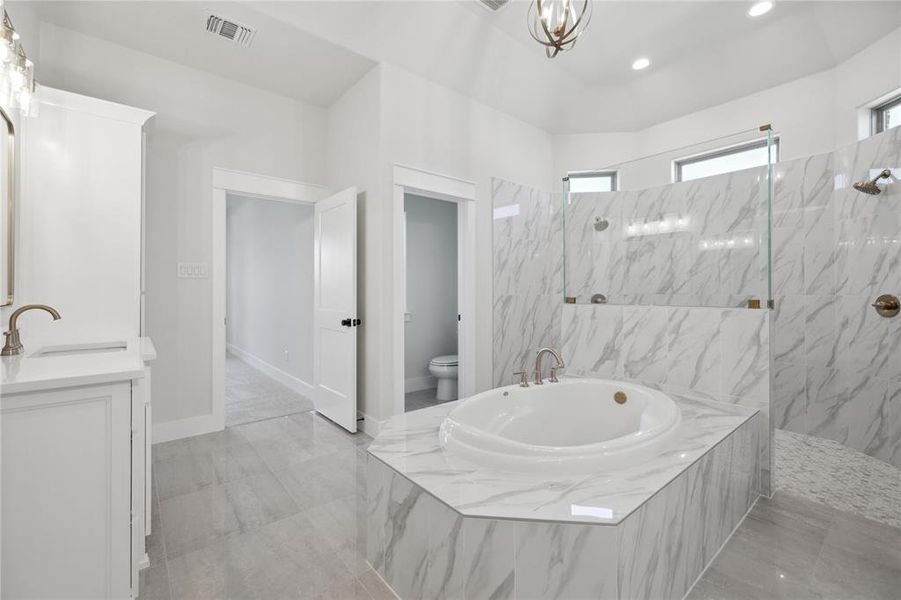 Full bathroom with separate shower and tub, tile patterned floors, and sink