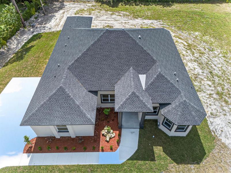 Front exterior of a new home in , The Acreage, FL, highlighting curb appeal (Image 26). Front exterior of a new home in , The Acreage, FL, highlighting curb appeal (Image 26).