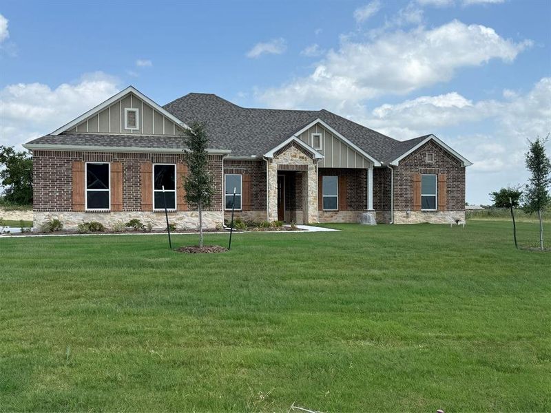 Front exterior of a new home in Windmill Creeks, Weatherford, TX, highlighting curb appeal (Image 2). Front exterior of a new home in Windmill Creeks, Weatherford, TX, highlighting curb appeal (Image 2).