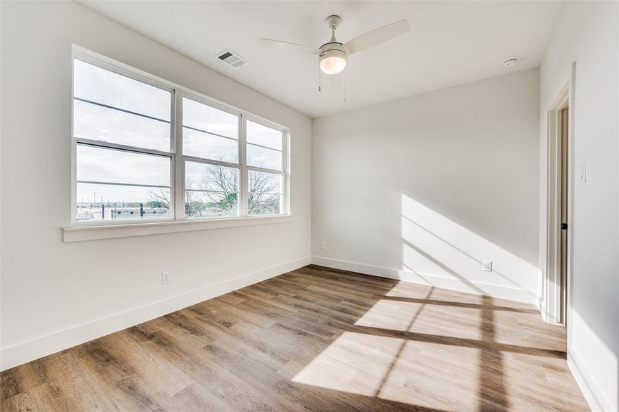 Unfurnished room featuring ceiling fan and wood-type flooring