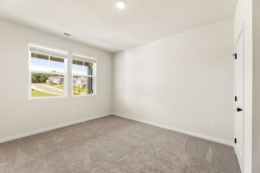 A room with a carpet and a window. A room with a carpet and a window.