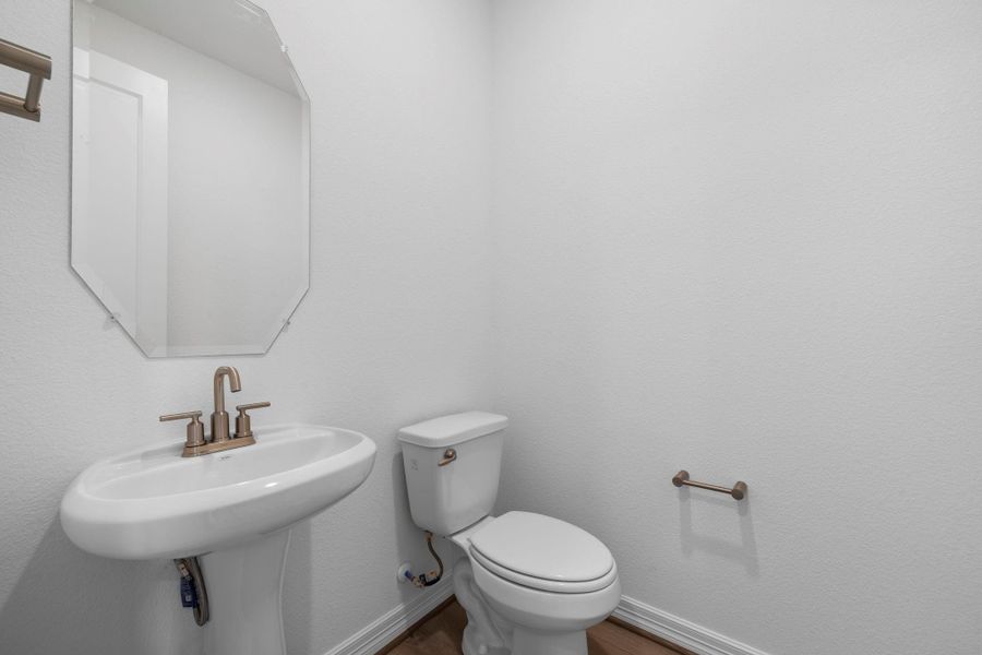 This charming home features a beautifully appointed half bath adjacent to the family room, perfect for welcoming guests and adding convenience to your daily life.