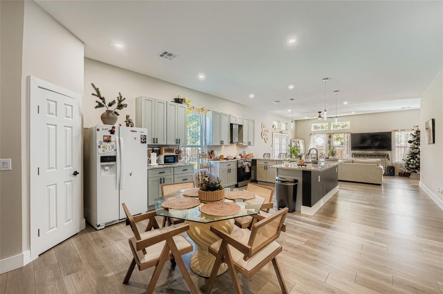 Dining space with light wood-style floors and recessed lighting Dining space with light wood-style floors and recessed lighting