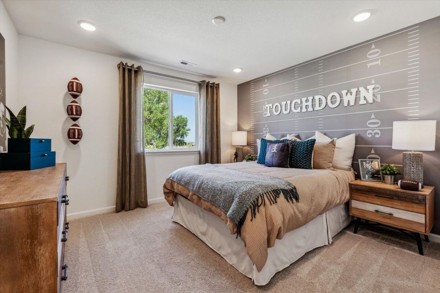 A bedroom with a bed and a desk. A bedroom with a bed and a desk.