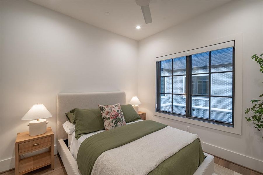 Bedroom with hardwood / wood-style flooring and ceiling fan