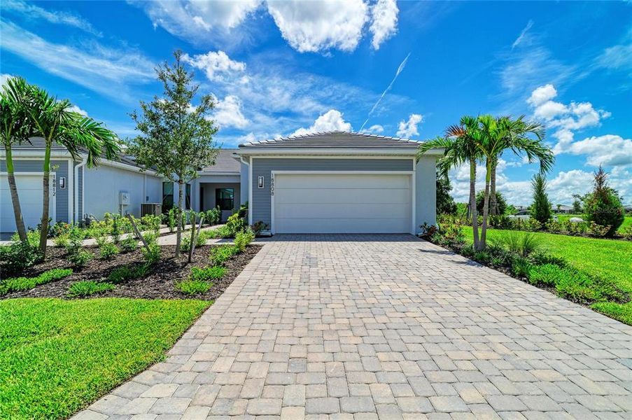 Front exterior of a new home in , Lakewood Ranch, FL, highlighting curb appeal (Image 27). Front exterior of a new home in , Lakewood Ranch, FL, highlighting curb appeal (Image 27).