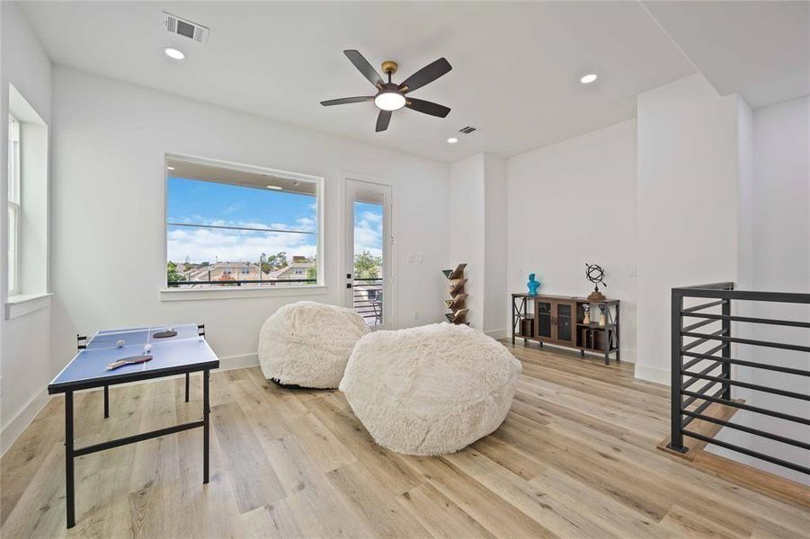 What a terrific space with high ceilings for a gameroom, retreat, a home office, or workout area. The glass insert door to the right leads to an oversized balcony. Beautiful solid wrought iron railings add modern charm and functionality to the space.