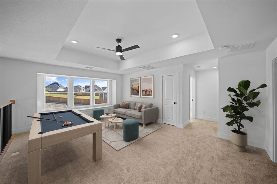 Recreation room with a tray ceiling, light carpet, a ceiling fan, billiards table, and recessed lighting Recreation room with a tray ceiling, light carpet, a ceiling fan, billiards table, and recessed lighting