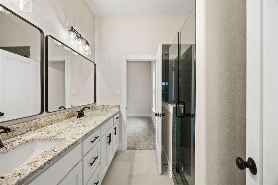 Bathroom featuring double vanity and a stall shower Bathroom featuring double vanity and a stall shower