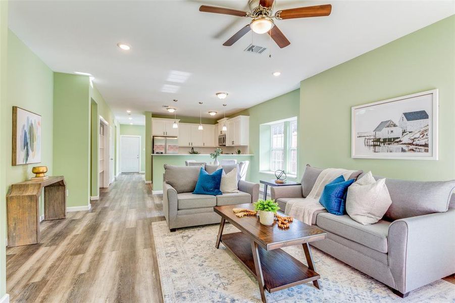 Living room featuring light wood-type flooring and ceiling fan