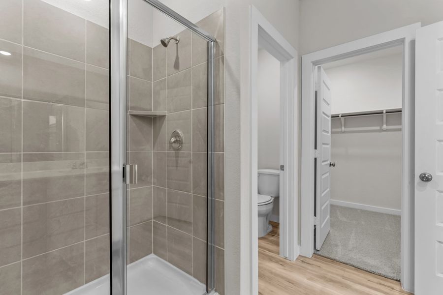 A bathroom with a glass shower. A bathroom with a glass shower.