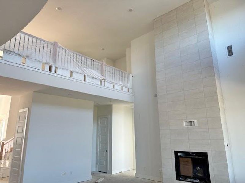 Family Room with soaring ceiling & fireplace