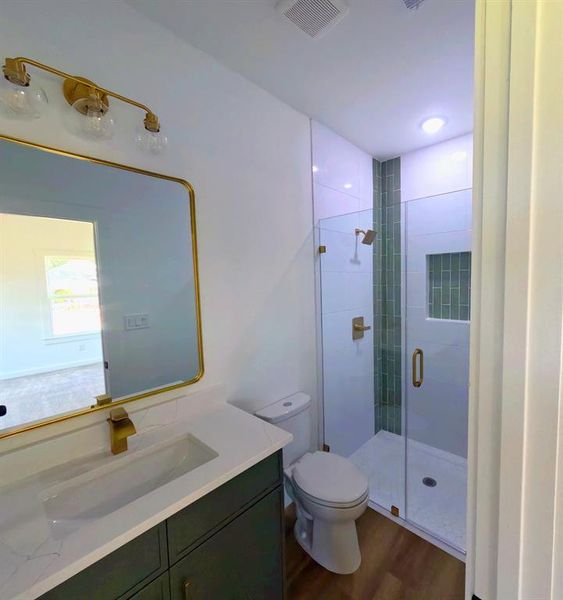 Full bathroom featuring vanity, a stall shower, and dark wood finished floors Full bathroom featuring vanity, a stall shower, and dark wood finished floors