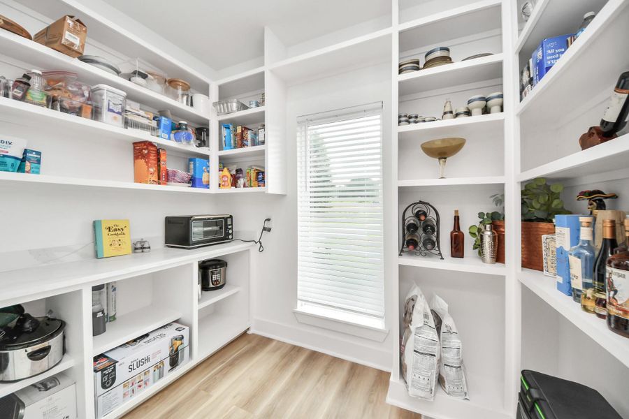 Spacious walk-in pantry with abundant shelving, natural light, and ample storage for all your kitchen essentials. Spacious walk-in pantry with abundant shelving, natural light, and ample storage for all your kitchen essentials.