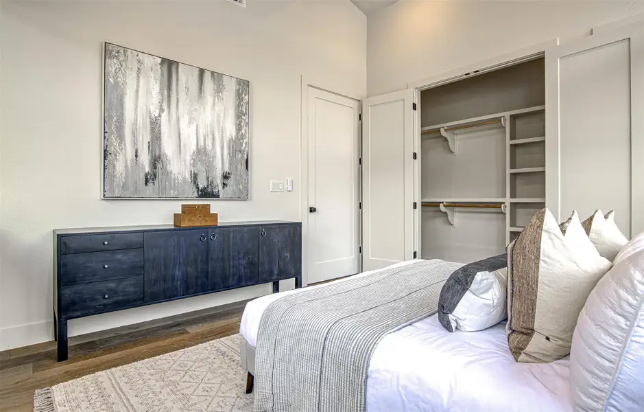 Bedroom with wood finished floors and a closet Bedroom with wood finished floors and a closet