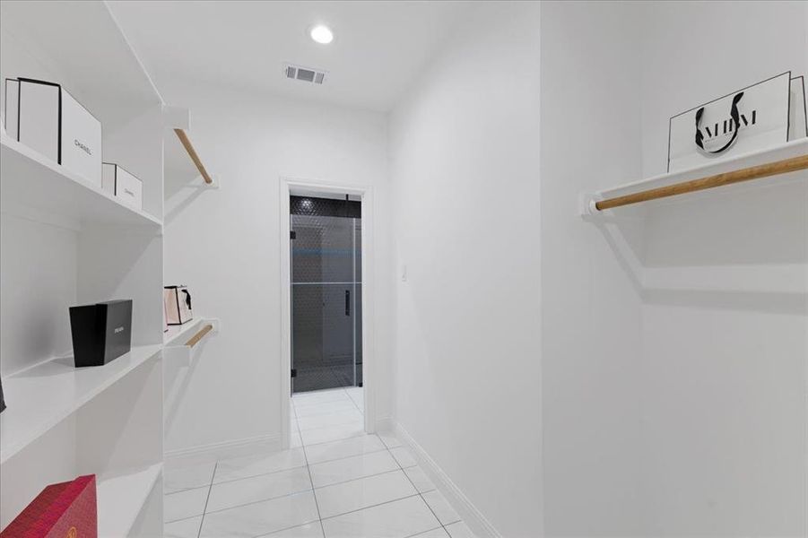 Corridor with light tile patterned floors, baseboards, visible vents, and recessed lighting