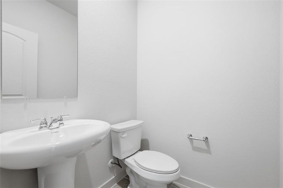 Pedestal sink with chrome fixtures and a rectangular mirror Pedestal sink with chrome fixtures and a rectangular mirror