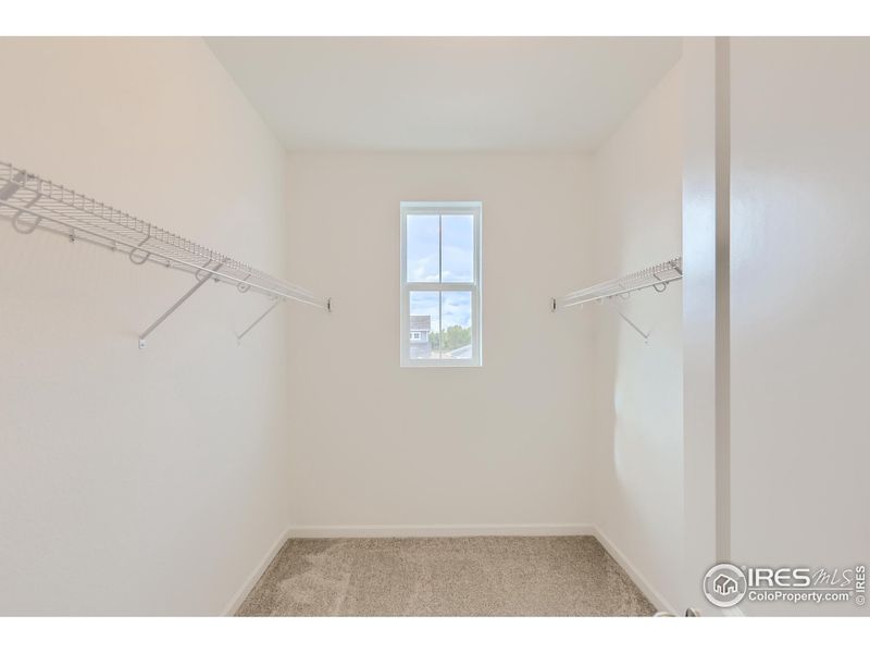 Primary walk in closet *Photo not of exact home, but same floorplan*