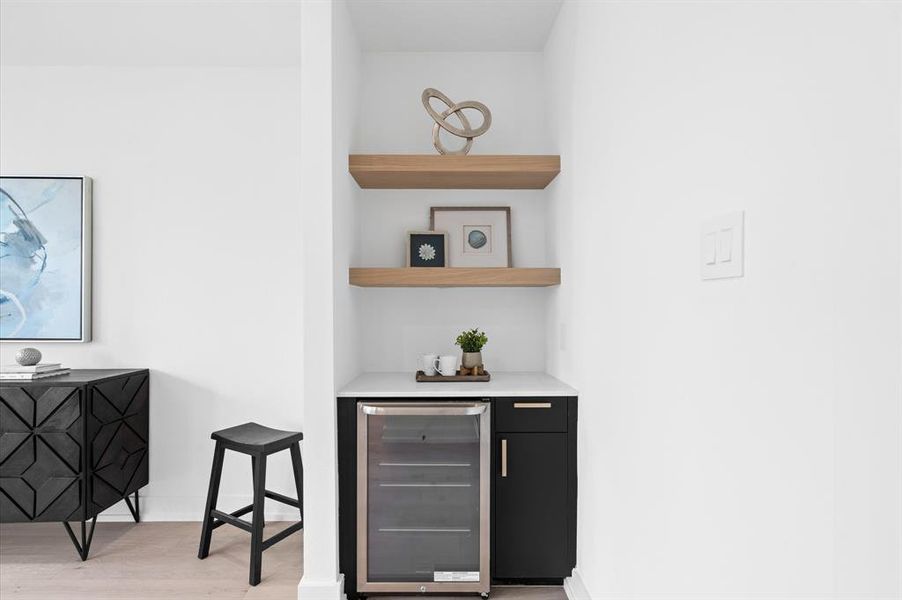 Primary bedroom boasts a mini fridge/coffee bar.