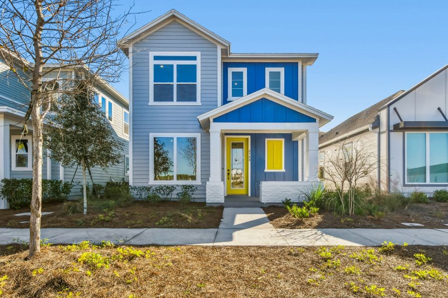 Front exterior of a new home in Weslyn Park in Sunbridge 34', St. Cloud, FL, highlighting curb appeal (Image 1).
