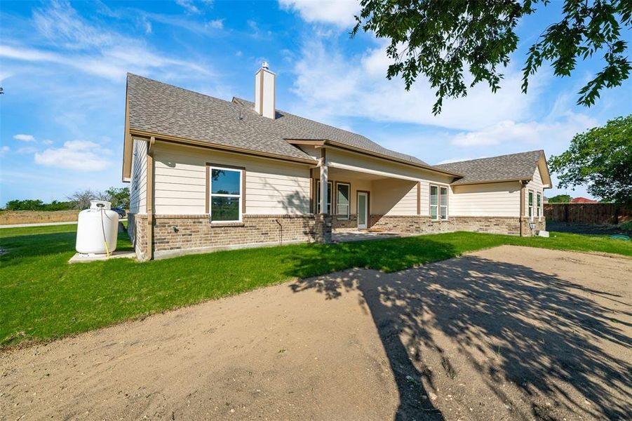 View of front of home with brick siding, a chimney, and roof with shingles View of front of home with brick siding, a chimney, and roof with shingles