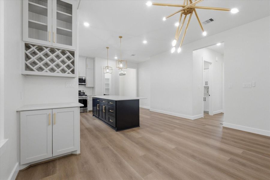 Stunning dining area featuring a built-in beverage station, perfect for a coffee bar, dry bar, or buffet setup when entertaining. Stunning dining area featuring a built-in beverage station, perfect for a coffee bar, dry bar, or buffet setup when entertaining.