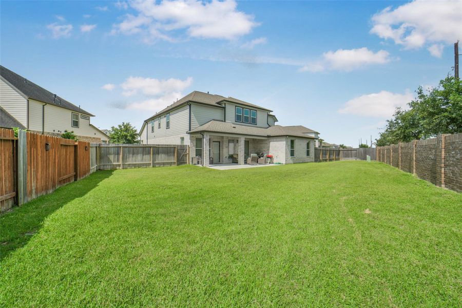 Large fenced yard provides plenty of room for pets and activities.