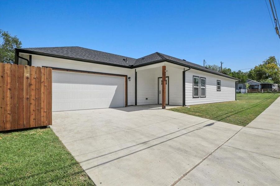View of front of home with concrete driveway, an attached garage, and roof with shingles View of front of home with concrete driveway, an attached garage, and roof with shingles