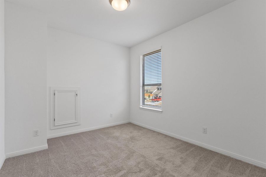 Spare room featuring light colored carpet and baseboards