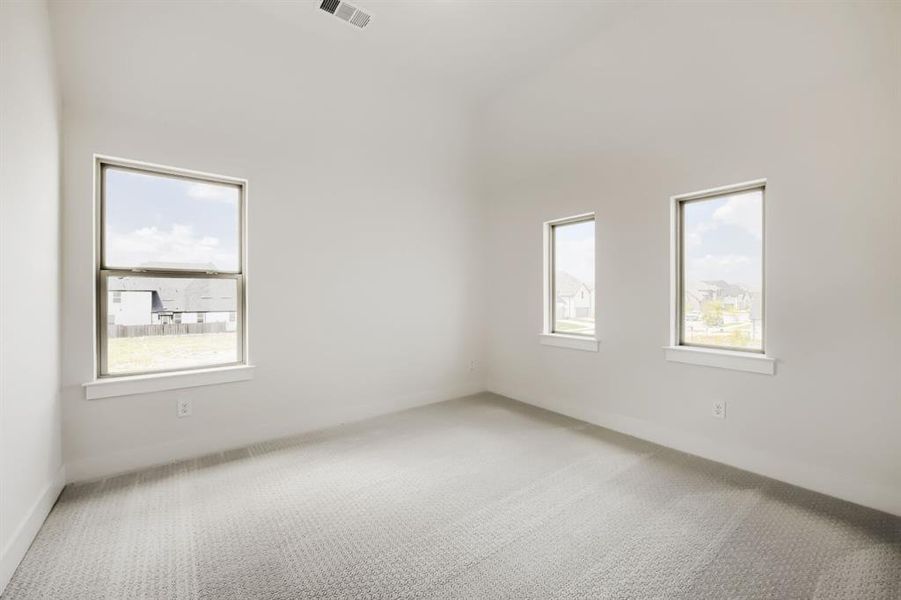 Bright interior featuring light-colored walls and patterned carpeting Bright interior featuring light-colored walls and patterned carpeting