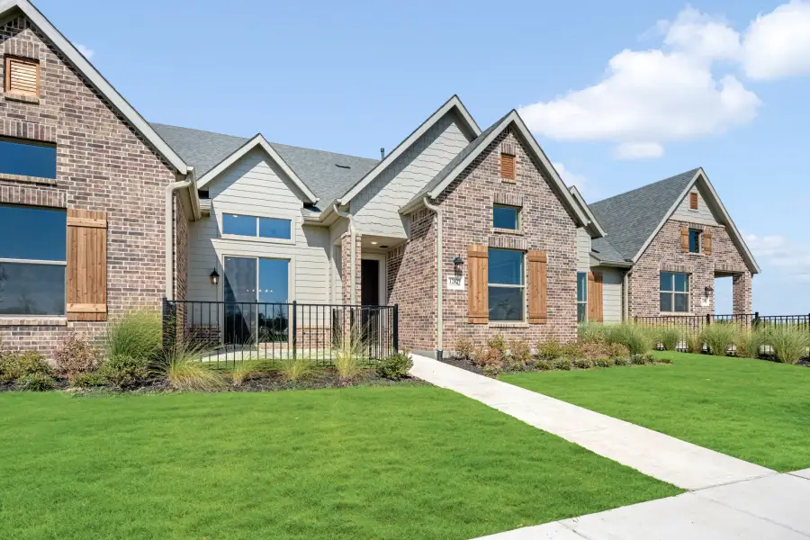 Front exterior of a new home in Cottonwood Creek, Rowlett, TX, highlighting curb appeal (Image 25). Front exterior of a new home in Cottonwood Creek, Rowlett, TX, highlighting curb appeal (Image 25).