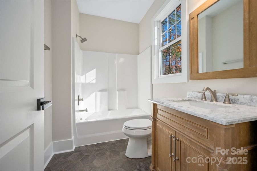 Guest bathroom on the main level with marble vanity top