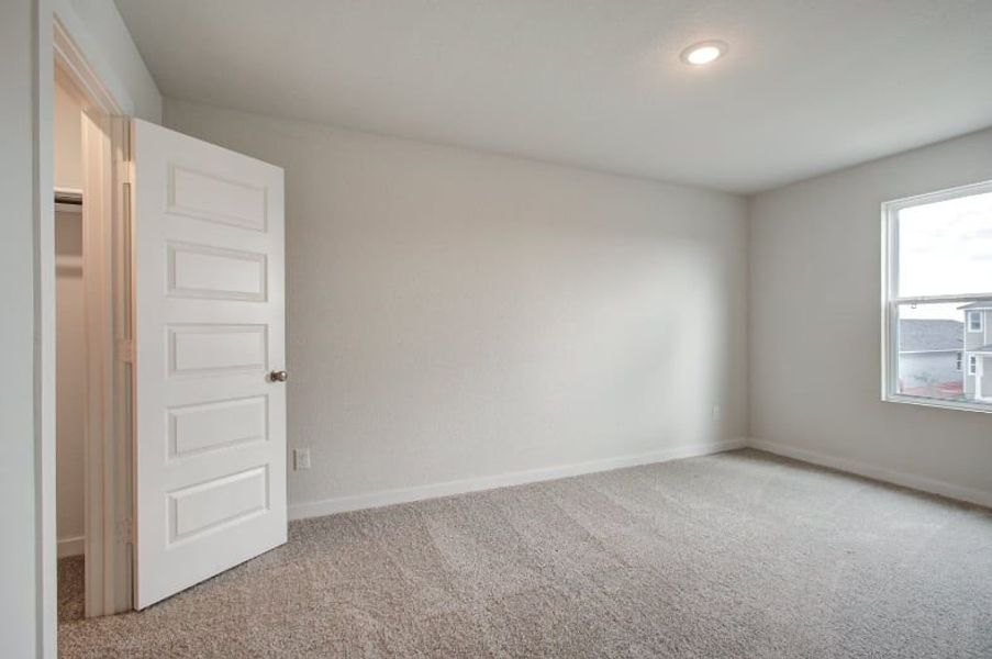 A room with a white door and a window. A room with a white door and a window.