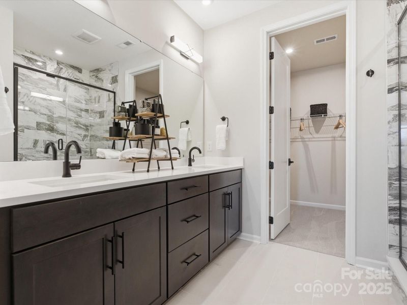 En Suite Primary Bath with Dual Vanity and Drawer Bank for Convenient Storage. *Model Photos | Actual Finishes, Structural Selections, and Orientation May Vary. En Suite Primary Bath with Dual Vanity and Drawer Bank for Convenient Storage. *Model Photos | Actual Finishes, Structural Selections, and Orientation May Vary.