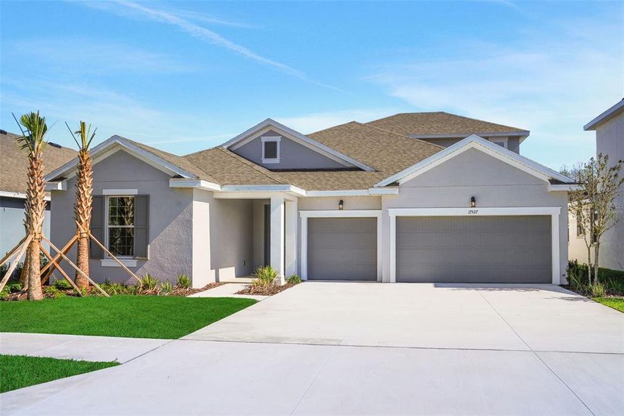Front exterior of a new home in Angeline, Land O' Lakes, FL, highlighting curb appeal (Image 19).