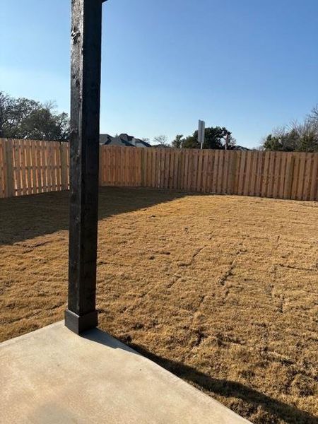 View of yard featuring a fenced backyard and a patio