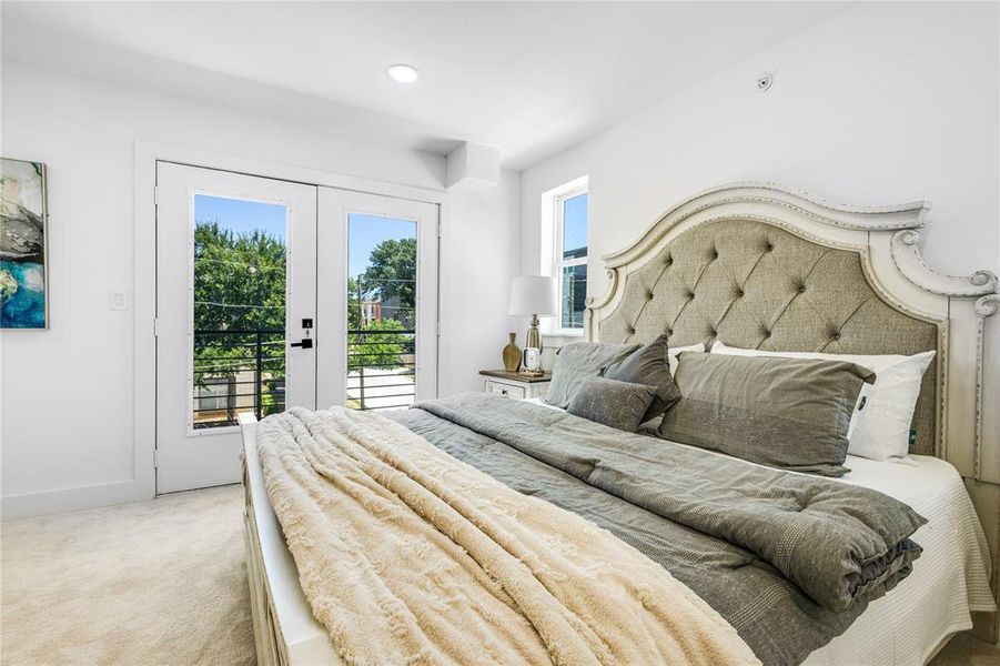 Bedroom featuring french doors, carpet flooring, and access to exterior