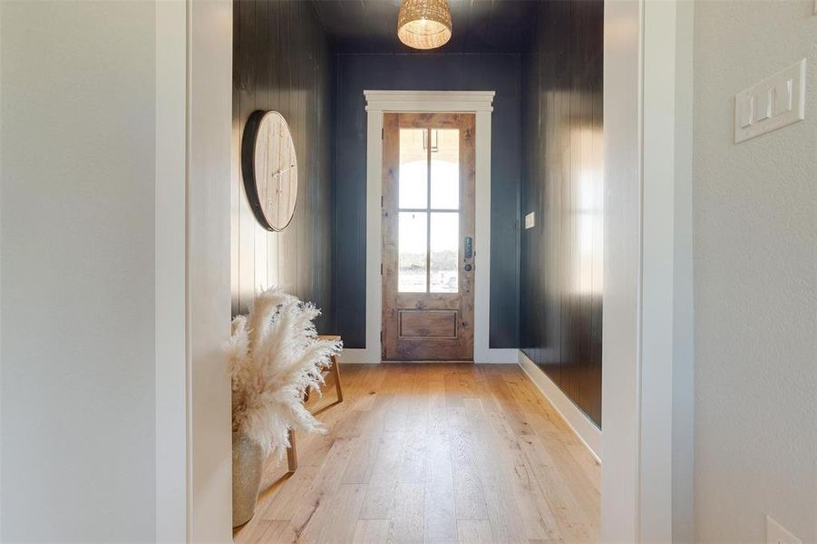 Doorway to outside with light wood-type flooring