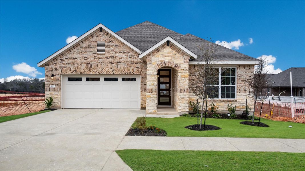 Front exterior of a new home in Rosenbusch Ranch, Leander, TX, highlighting curb appeal (Image 22). Front exterior of a new home in Rosenbusch Ranch, Leander, TX, highlighting curb appeal (Image 22).