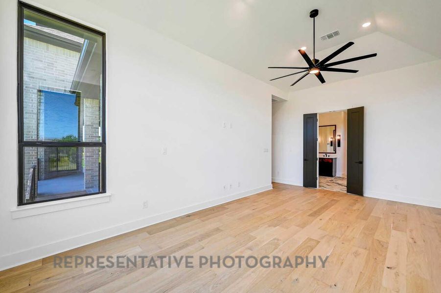 Spare room featuring light wood-type flooring, a ceiling fan, and lofted ceiling Spare room featuring light wood-type flooring, a ceiling fan, and lofted ceiling