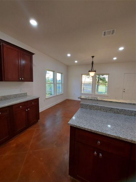 Lots of natural light in the kitchen and dining area which faces the back patio and beautiful country views.