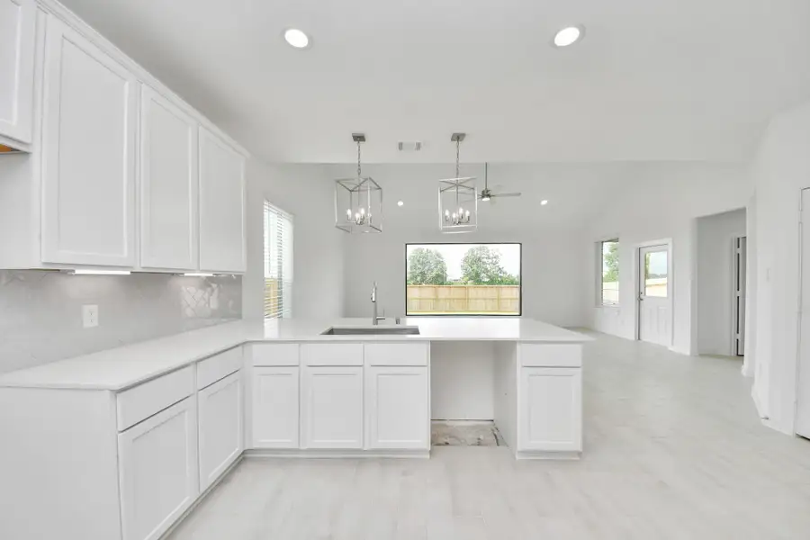 The open concept effortlessly connects the kitchen to the expansive family room, forming a perfect hub for gatherings. This seamless flow creates an inviting space where cooking and socializing come together harmoniously.