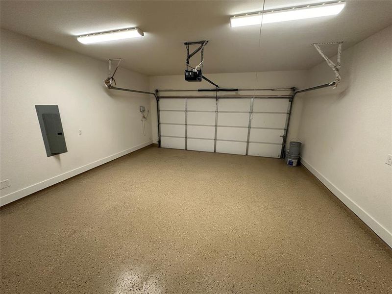 Garage with a garage door opener and electric panel