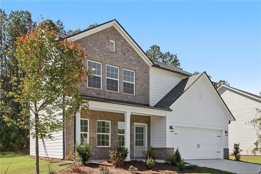 Front exterior of a new home in The Pointe at Heron Bay, Locust Grove, GA, highlighting curb appeal (Image 2).