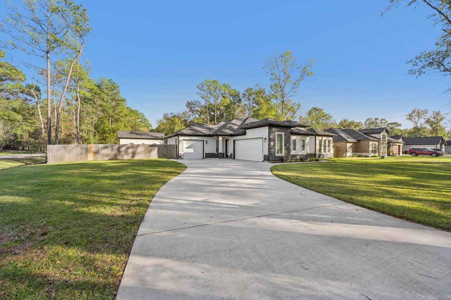 Front exterior of a new home in , Magnolia, TX, highlighting curb appeal (Image 1).