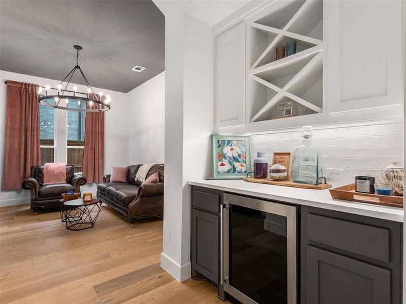 A dry bar is next to the den