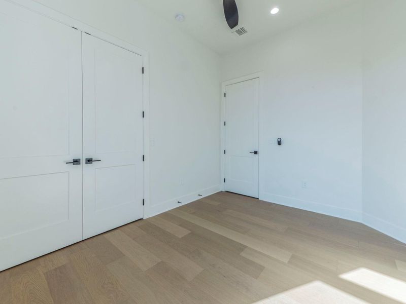 Unfurnished bedroom with wood finished floors, a closet, recessed lighting, and a ceiling fan Unfurnished bedroom with wood finished floors, a closet, recessed lighting, and a ceiling fan