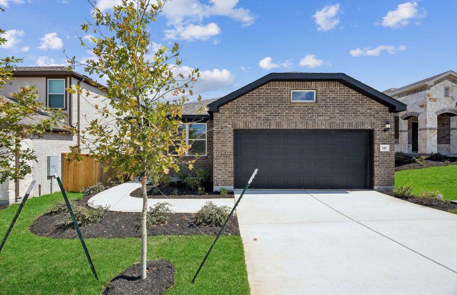 Front exterior of a new home in La Cima, San Marcos, TX, highlighting curb appeal (Image 19).