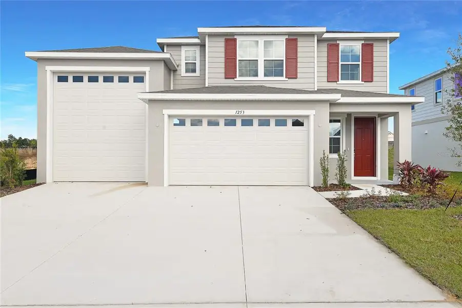Front exterior of a new home in Seasons at Bella Vista, Dundee, FL, highlighting curb appeal (Image 1). Front exterior of a new home in Seasons at Bella Vista, Dundee, FL, highlighting curb appeal (Image 1).