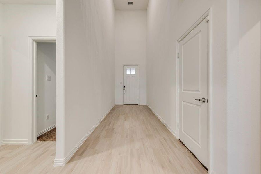 Hallway with light hardwood / wood-style floors